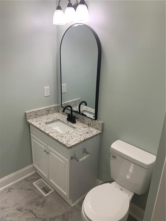 bathroom with tile patterned flooring, toilet, and vanity