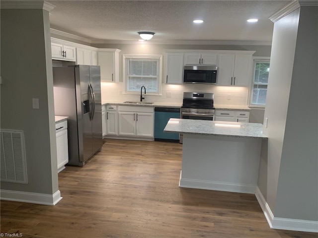 kitchen featuring white cabinetry, stainless steel appliances, hardwood / wood-style floors, and sink