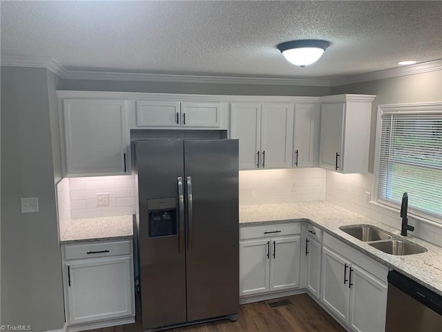 kitchen featuring sink, crown molding, appliances with stainless steel finishes, white cabinetry, and light stone countertops