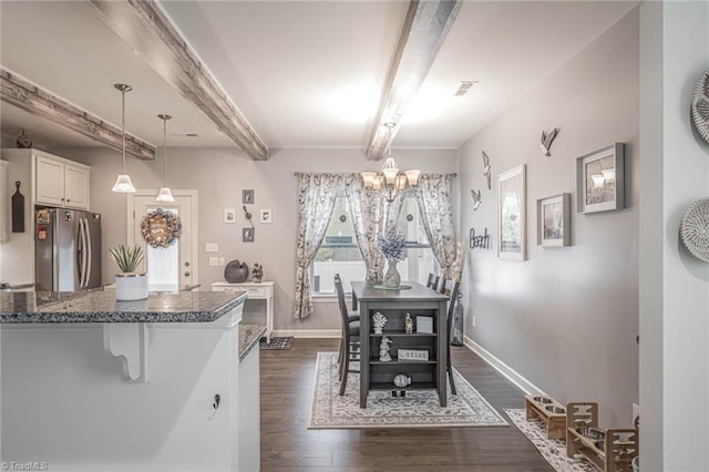 dining space featuring visible vents, baseboards, dark wood-style flooring, beam ceiling, and a notable chandelier