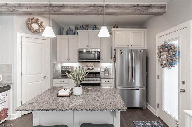 kitchen featuring stainless steel appliances, white cabinets, beamed ceiling, and tasteful backsplash