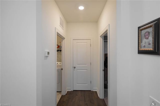 hall with washer / clothes dryer, dark wood finished floors, and visible vents