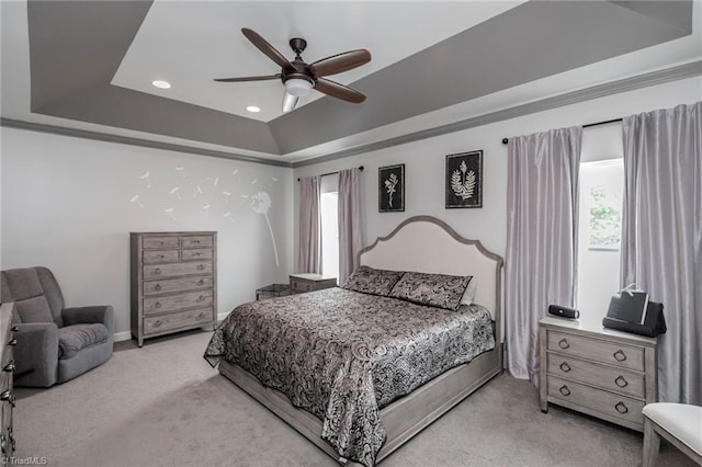 bedroom featuring recessed lighting, light carpet, a ceiling fan, baseboards, and a raised ceiling