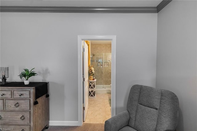 sitting room with baseboards and crown molding