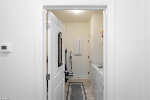 laundry room featuring laundry area, electric panel, baseboards, and independent washer and dryer