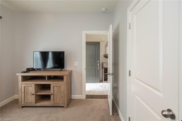 interior space featuring light carpet and baseboards