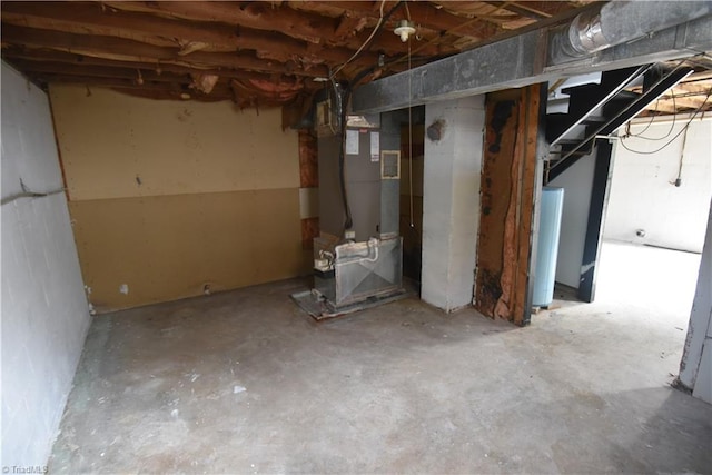 basement featuring heating unit and water heater