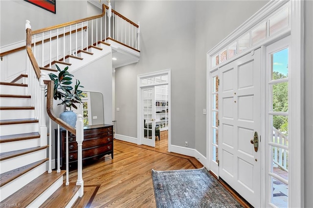 3940 Beechridge Rd, Winston-Salem, NC 27106 - foyer featuring wood finished floors, stairs, a towering ceiling, and baseboards
