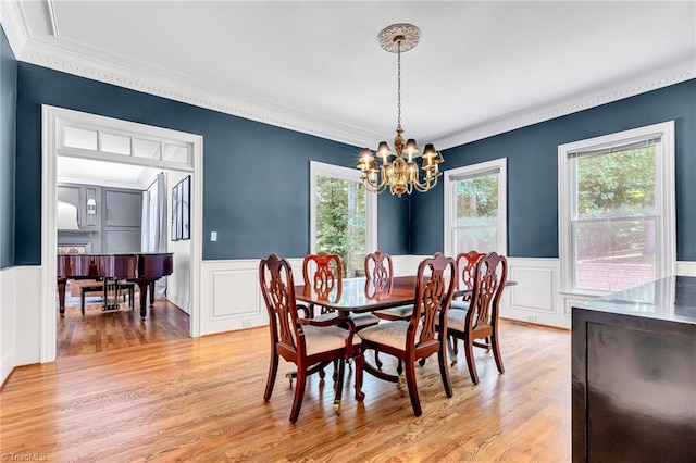 3940 Beechridge Rd, Winston-Salem, NC 27106 - dining area featuring a wainscoted wall, ornamental molding, a chandelier, light wood-type flooring, and a decorative wall