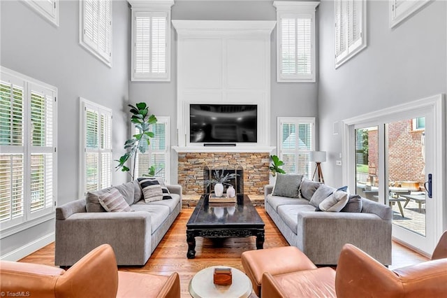 3940 Beechridge Rd, Winston-Salem, NC 27106 - living room featuring a high ceiling, light wood-style floors, a fireplace, and baseboards