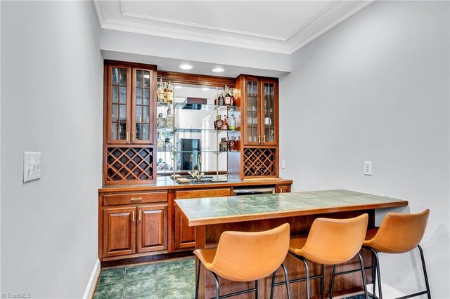 3940 Beechridge Rd, Winston-Salem, NC 27106 - indoor bar with baseboards, crown molding, and backsplash
