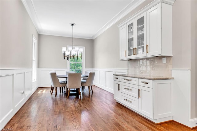 3940 Beechridge Rd, Winston-Salem, NC 27106 - dining room with ornamental molding, wood finished floors, a chandelier, wainscoting, and a decorative wall