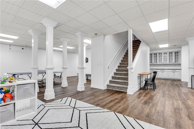 3940 Beechridge Rd, Winston-Salem, NC 27106 - living room with wood finished floors, stairs, ornate columns, baseboards, and a paneled ceiling