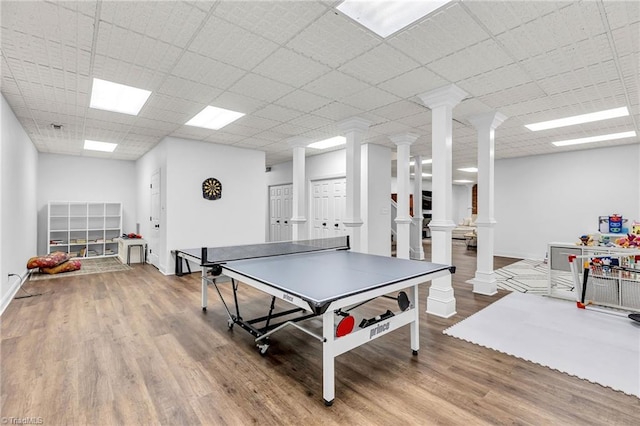 3940 Beechridge Rd, Winston-Salem, NC 27106 - recreation room featuring decorative columns, wood finished floors, baseboards, and a paneled ceiling