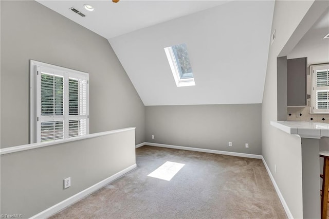 3940 Beechridge Rd, Winston-Salem, NC 27106 - bonus room with a skylight, vaulted ceiling, carpet, healthy amount of natural light, and baseboards