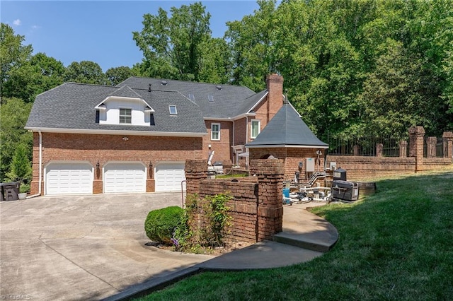 3940 Beechridge Rd, Winston-Salem, NC 27106 - rear view of property with brick siding, concrete driveway, and a chimney