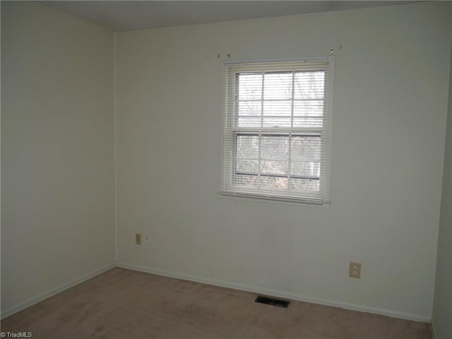 unfurnished room with light colored carpet