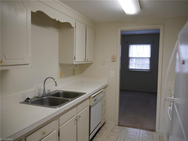 kitchen with white cabinetry, white appliances, and sink