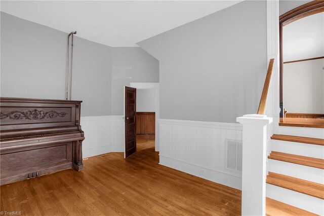 stairway with hardwood / wood-style flooring