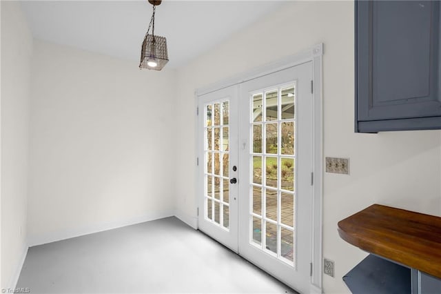 entryway with concrete floors and french doors