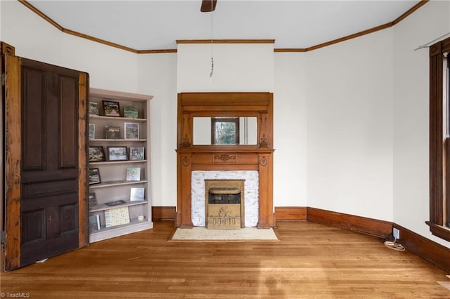 unfurnished living room featuring hardwood / wood-style flooring and ornamental molding