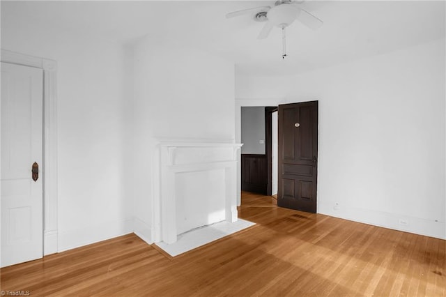 empty room with hardwood / wood-style floors and ceiling fan