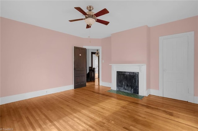 unfurnished living room featuring ceiling fan and wood-type flooring