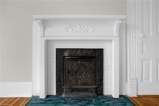 details with hardwood / wood-style floors and a fireplace