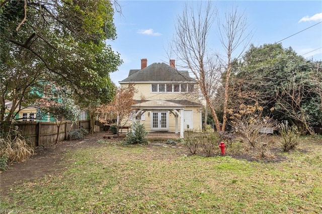 rear view of property featuring a yard and french doors