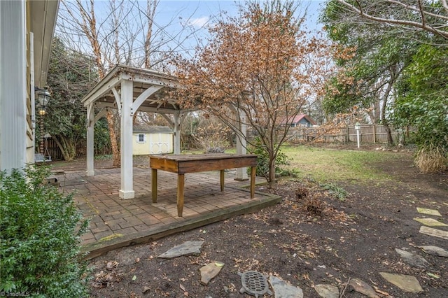 view of yard featuring a gazebo, a storage unit, and a patio