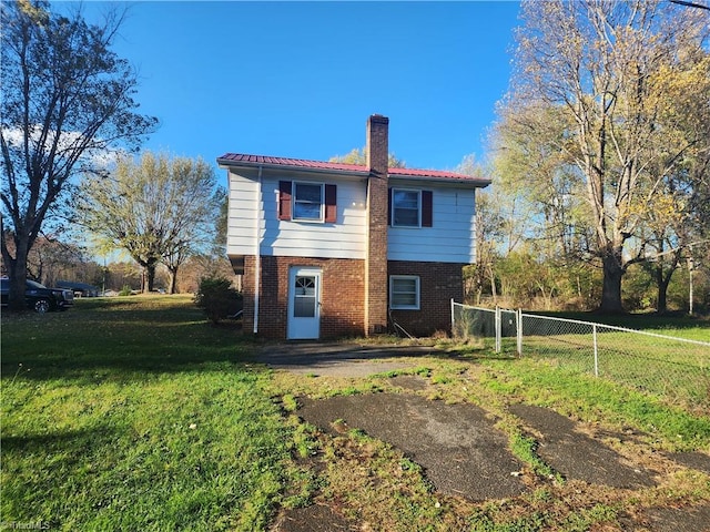 rear view of house with a lawn