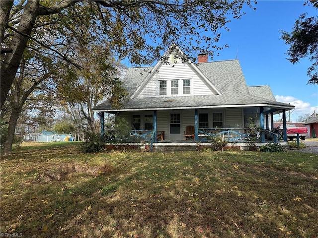 farmhouse-style home with a front lawn and covered porch