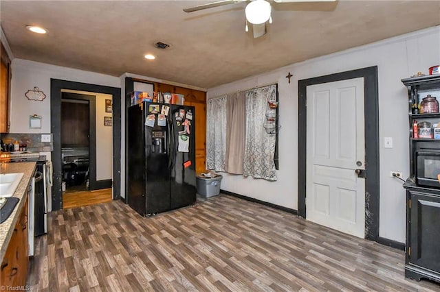 kitchen with ceiling fan, black fridge with ice dispenser, and dark hardwood / wood-style floors