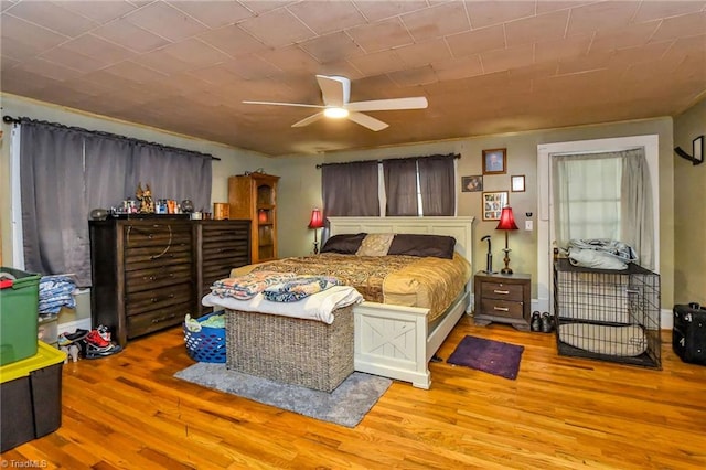 bedroom with light hardwood / wood-style floors and ceiling fan