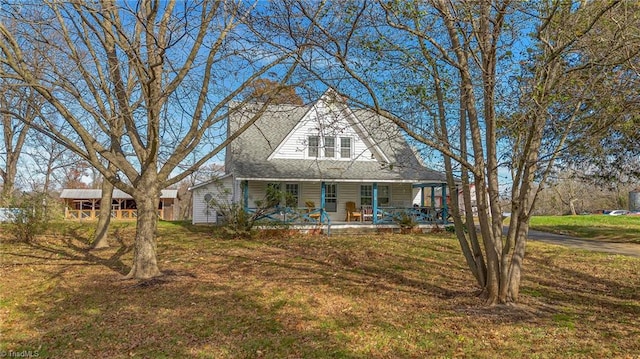 view of front of property with a porch and a front yard