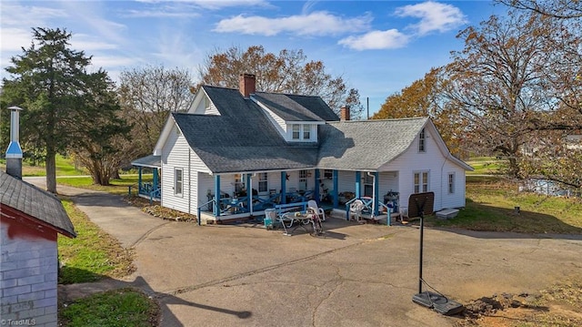 back of property featuring a porch