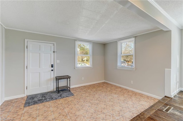 entryway with a textured ceiling and crown molding