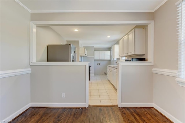 kitchen featuring stainless steel refrigerator with ice dispenser, ornamental molding, white cabinetry, and hardwood / wood-style flooring