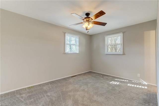 spare room featuring ceiling fan and light colored carpet