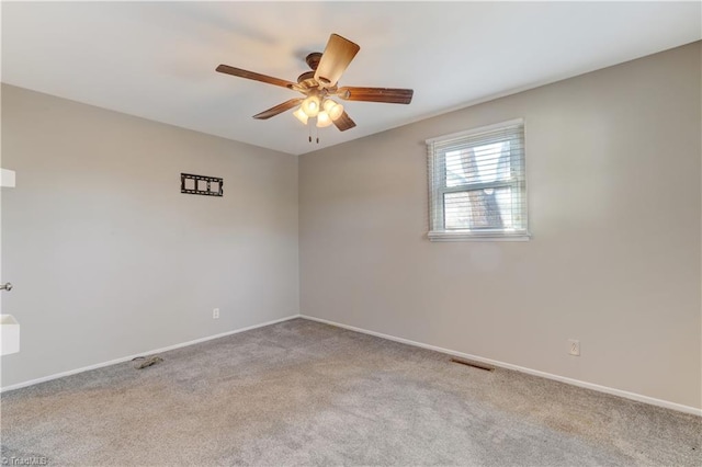 carpeted spare room featuring ceiling fan