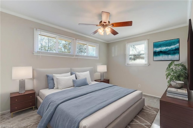 carpeted bedroom with ceiling fan and ornamental molding