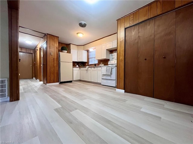 kitchen featuring white appliances, light wood-style flooring, visible vents, and white cabinetry