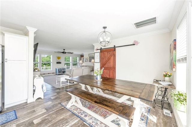214 Mining Ridge Church Rd, Elkin, NC 28621 - dining room with a barn door, ceiling fan, wood finished floors, ornamental molding, and a chandelier