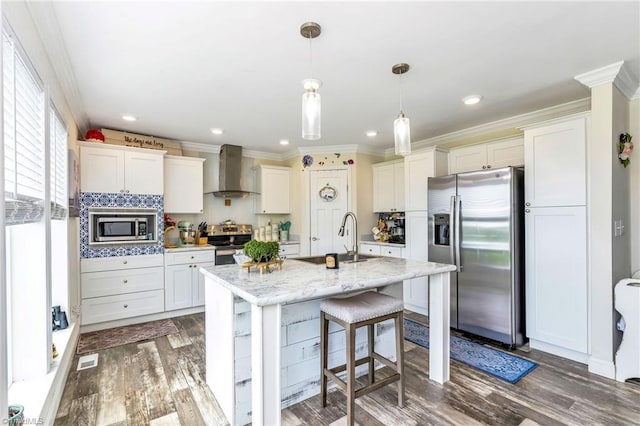 214 Mining Ridge Church Rd, Elkin, NC 28621 - kitchen featuring stainless steel appliances, wall chimney range hood, wood finished floors, crown molding, and white cabinets