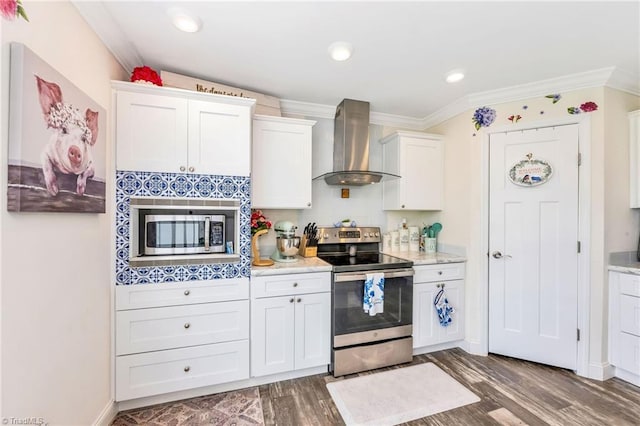 214 Mining Ridge Church Rd, Elkin, NC 28621 - kitchen featuring appliances with stainless steel finishes, wall chimney range hood, white cabinetry, ornamental molding, and wood finished floors