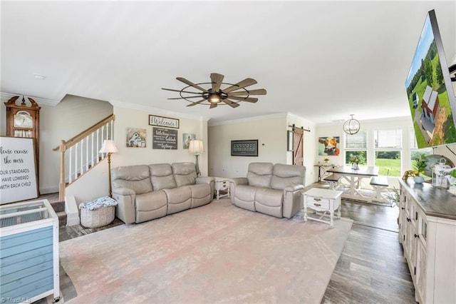 214 Mining Ridge Church Rd, Elkin, NC 28621 - living area featuring a barn door, ornamental molding, wood finished floors, a ceiling fan, and stairway
