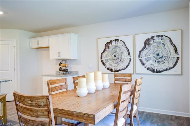 dining space featuring dark wood-type flooring