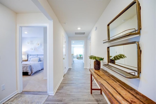 corridor with light hardwood / wood-style flooring