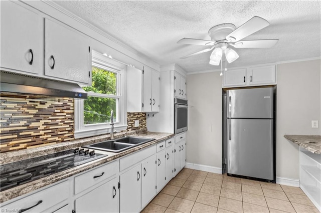 kitchen featuring stainless steel appliances, under cabinet range hood, a sink, ceiling fan, and white cabinetry
