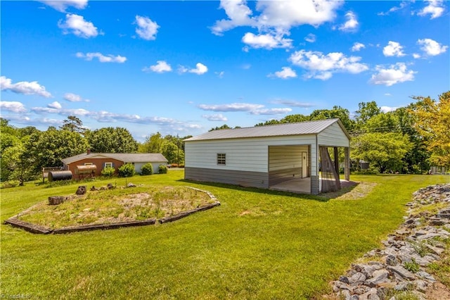 view of green lawn with an outbuilding